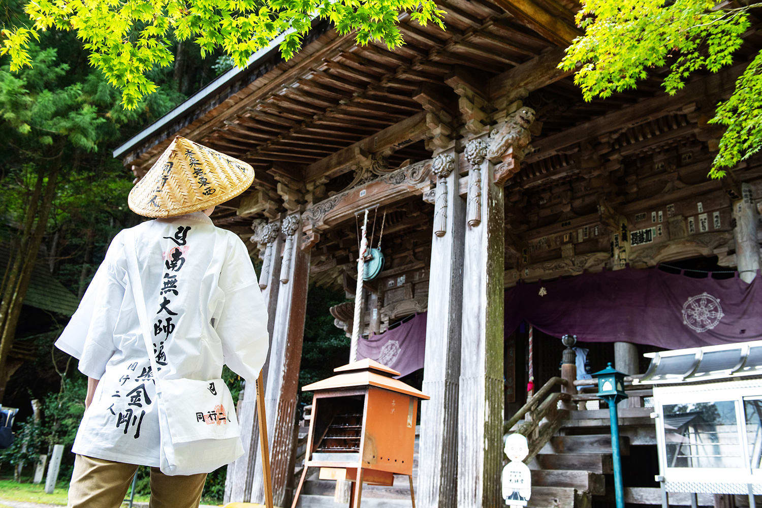Pilgrims in white vests and woven hats on the Shikoku pilgrimage trail